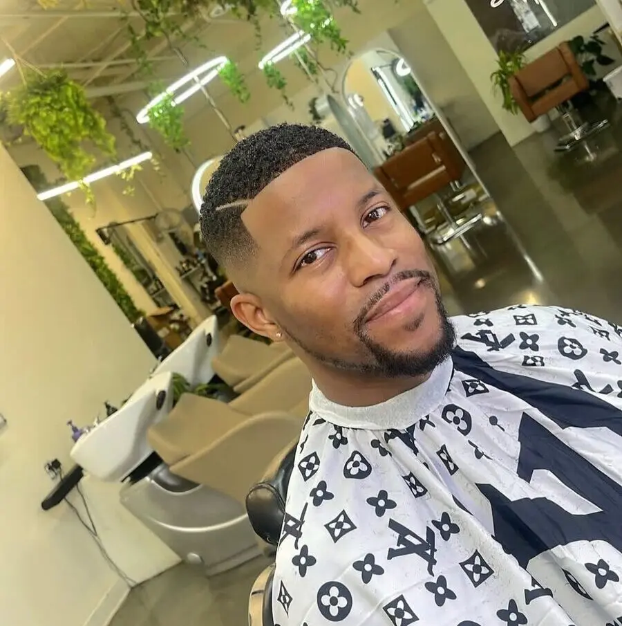 Smiling client with high skin fade, hard part, and sculpted beard by master barber Michael Fields at The Best Cuts, Hollywood Blvd Los Angeles