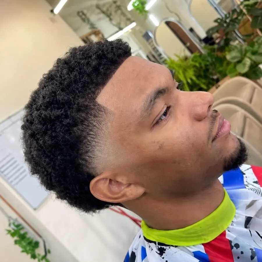 Curly taper fade with sharp lineup and mid drop fade on textured hair at The Best Cuts barbershop, Hollywood Los Angeles